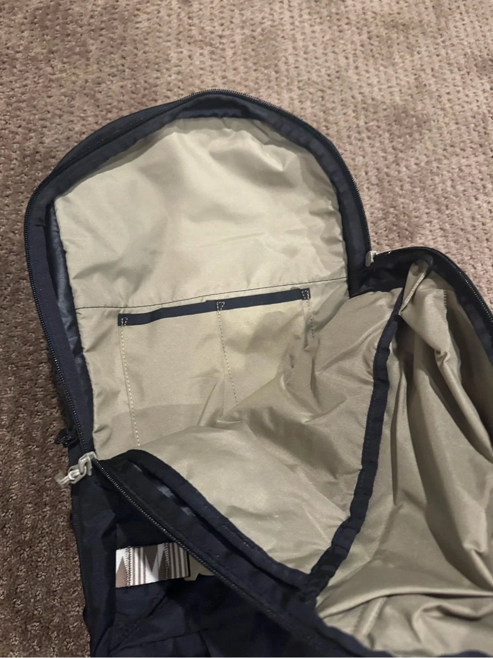 Dakine Black hydration Backpack with Tan Patterned Straps and hip straps